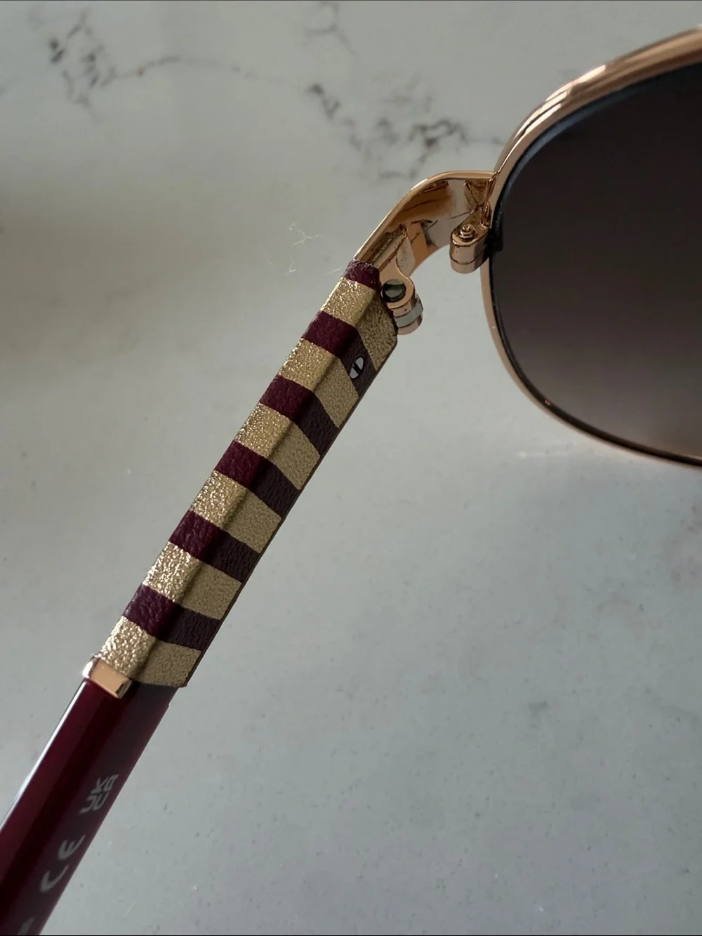 kate spade Rose Gold Frame Sunglasses with Burgundy Temples